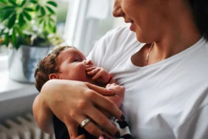 Mother cradling newborn baby