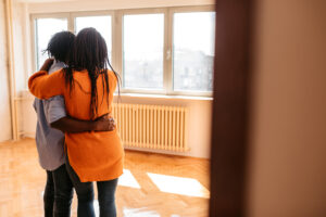Young couple standing in new apartment