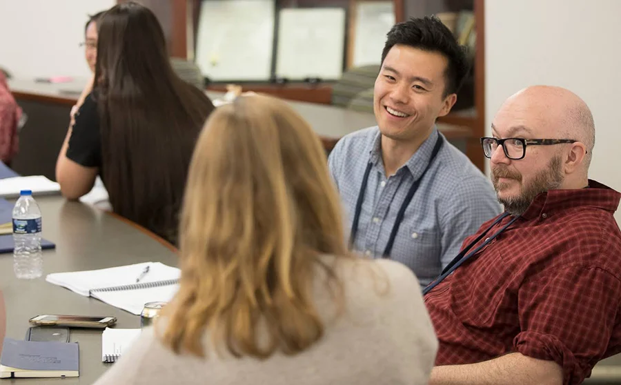 People laughing and talking in a training course