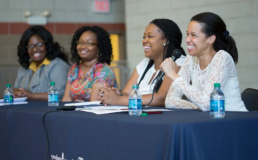 Four women speaking at a panel presentation