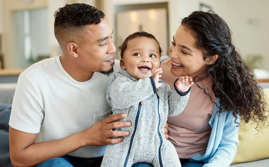 Young family bonding with their baby boy at home